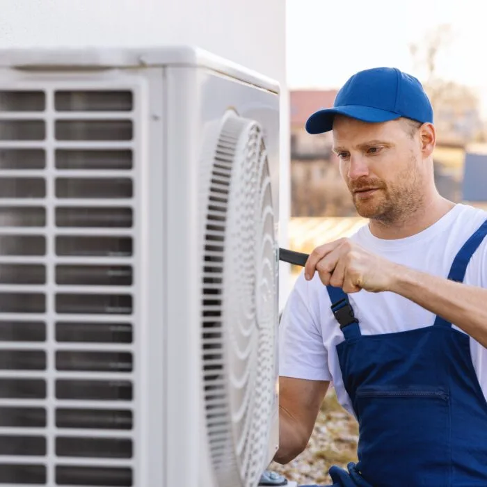 Technician,Working,On,Air,Conditioning,Or,Heat,Pump,Outdoor,Unit. AC Repair in Greenhill, VA | Service First Heating & Air-servicefirstva.com